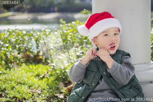 Image of Cute Mixed Race Boy With Santa Hat and Candy Cane