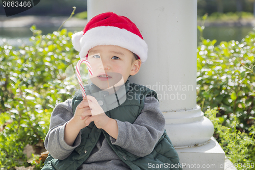 Image of Cute Mixed Race Boy With Santa Hat and Candy Cane