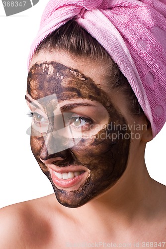 Image of Beautiful girl with mud mask on face