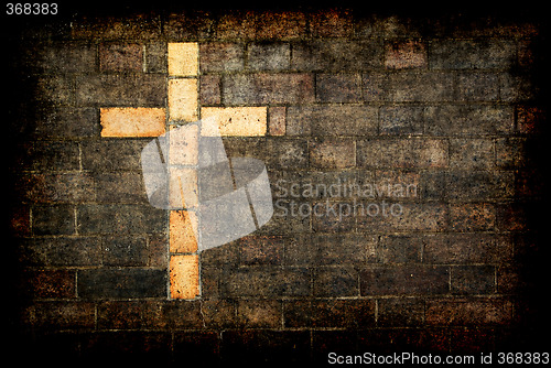 Image of cross of christ built into a brick wall