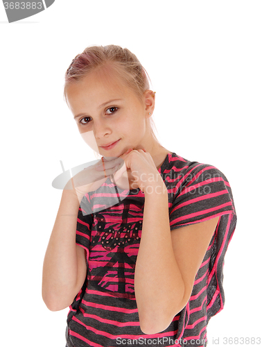 Image of Young girl with hands under chin.