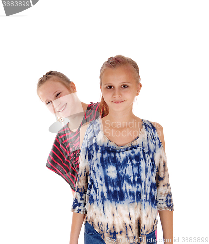 Image of Lovely sisters standing behind each other.