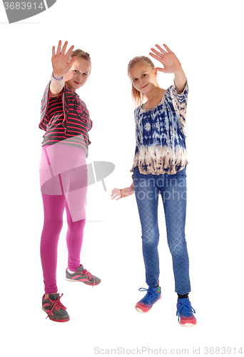 Image of Two girls holding there hands up.