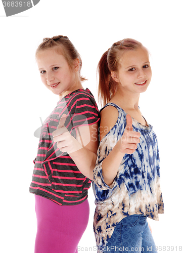 Image of Two sisters showing thump up.