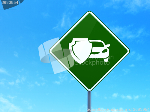 Image of Insurance concept: Car And Shield on road sign background
