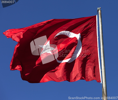 Image of Turkish flag waving in wind at sunny day