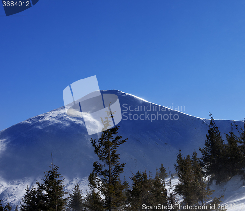 Image of Winter mountains at sunny windy day