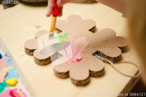 Image of Little female baby painting with colorful paints