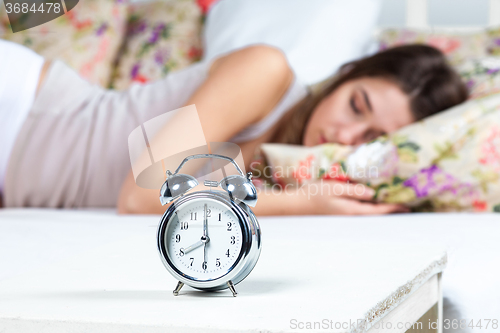 Image of The young girl sleeping in bed