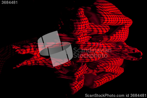 Image of The  body of woman with red pattern and its reflection