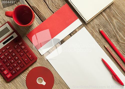 Image of The mockup on wooden background with red calculator