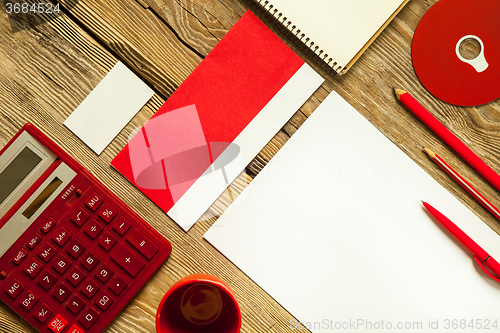 Image of The mockup on wooden background with red calculator