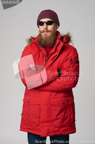 Image of Man wearing red winter Alaska jacket  with fur hood on