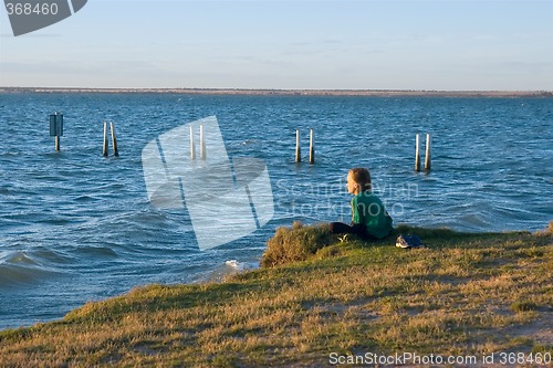 Image of boy looking over lake