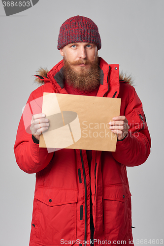Image of Man wearing red winter Alaska jacket  with fur hood on