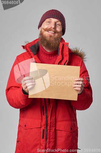 Image of Man wearing red winter Alaska jacket  with fur hood on