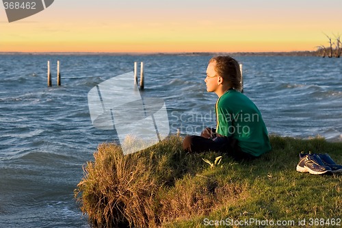 Image of boy looking over lake