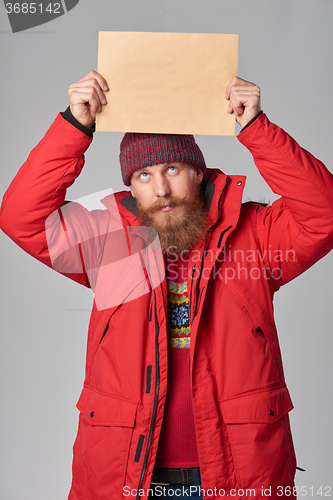 Image of Man wearing red winter Alaska jacket  with fur hood on
