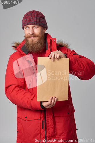 Image of Man wearing red winter Alaska jacket  with fur hood on