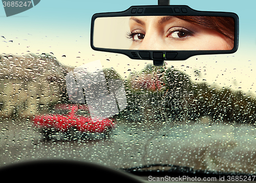 Image of driver looks to rearview mirror