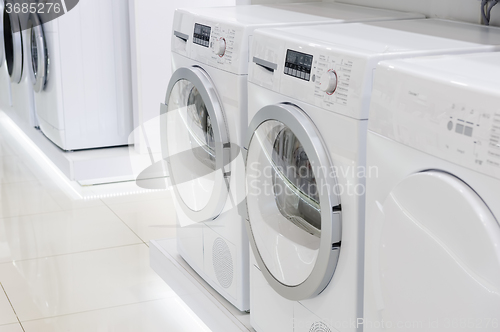 Image of laudry dryers and washing mashines in appliance store