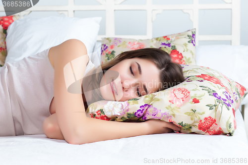 Image of The young girl sleeping in bed