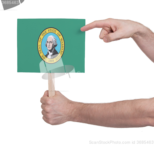 Image of Hand holding small card - Flag of Washington