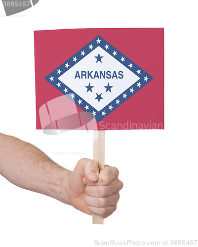 Image of Hand holding small card - Flag of Arkansas