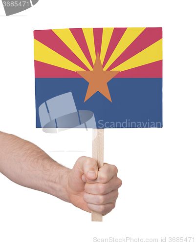 Image of Hand holding small card - Flag of Arizona