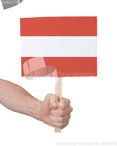 Image of Hand holding small card - Flag of Austria