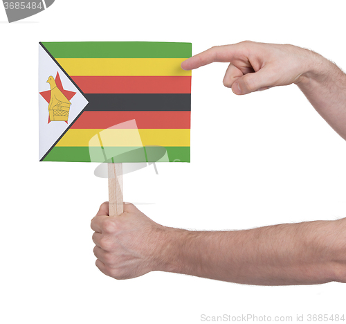 Image of Hand holding small card - Flag of Zimbabwe