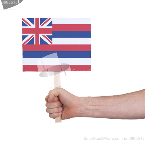 Image of Hand holding small card - Flag of Hawaii