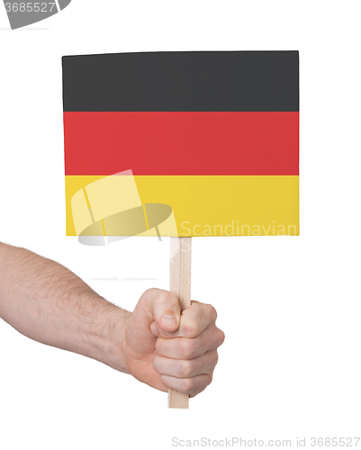 Image of Hand holding small card - Flag of Germany