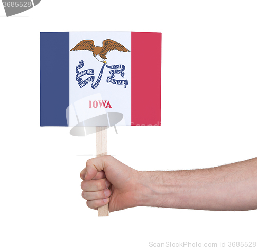 Image of Hand holding small card - Flag of Iowa