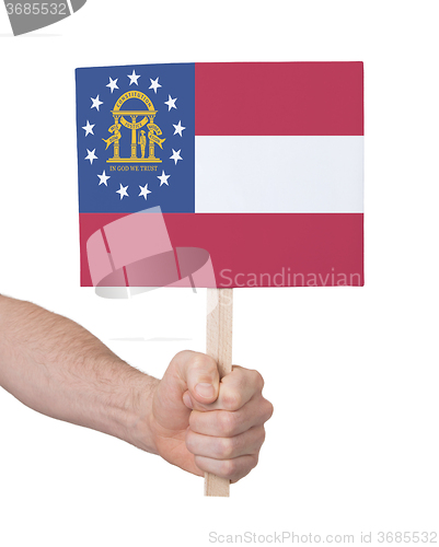 Image of Hand holding small card - Flag of Georgia