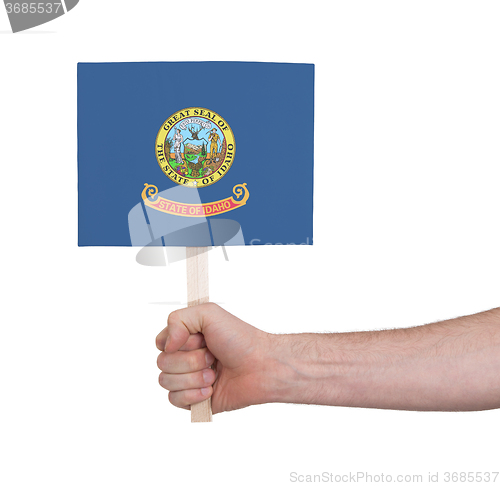 Image of Hand holding small card - Flag of Idaho
