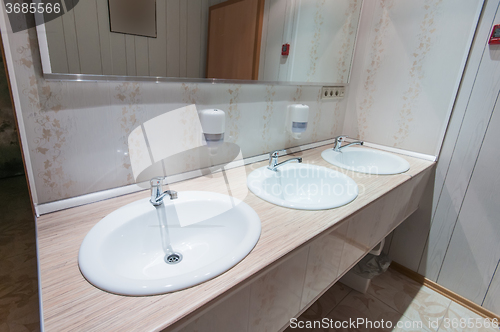 Image of bathroom with sinks in hostel