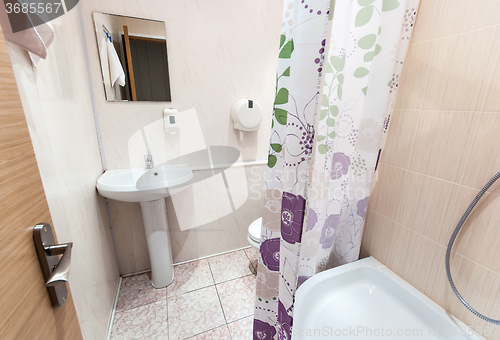 Image of bathroom with sink toilet and shower tray