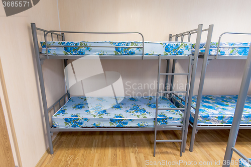 Image of bunk metal beds in hostel room