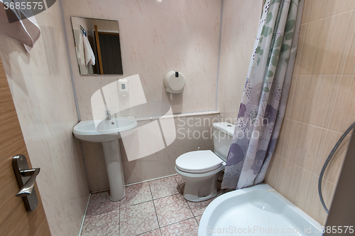 Image of bathroom with sink toilet and shower tray