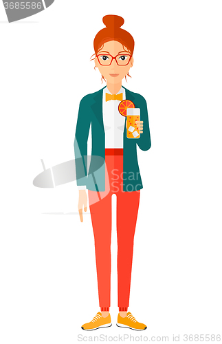 Image of Woman holding glass of juice.