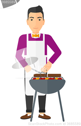 Image of Man preparing barbecue.