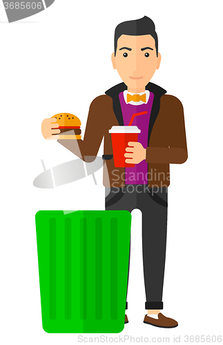 Image of Man throwing junk food.