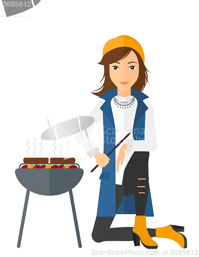 Image of Woman preparing barbecue.