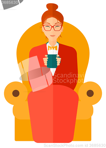 Image of Woman sitting in chair with cup of tea.