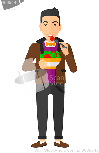 Image of Man eating salad.