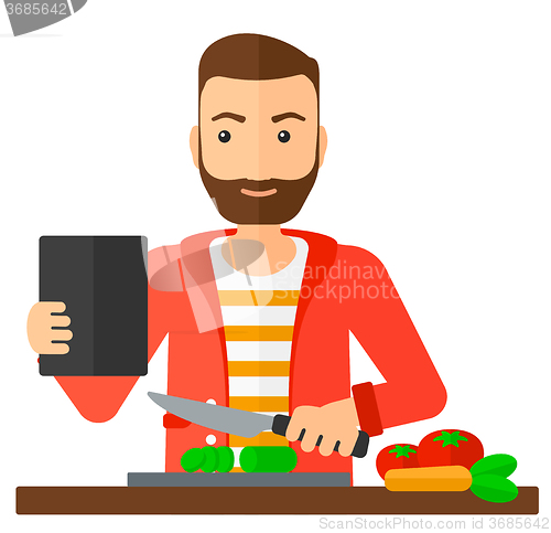 Image of Man cooking meal.