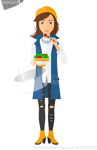 Image of Woman eating salad.