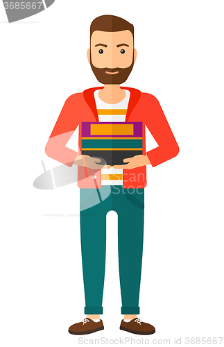 Image of Man holding pile of books.