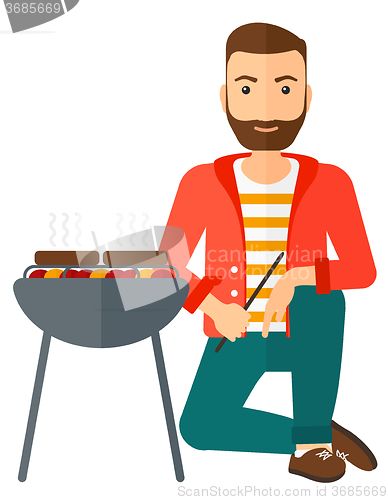 Image of Man preparing barbecue.